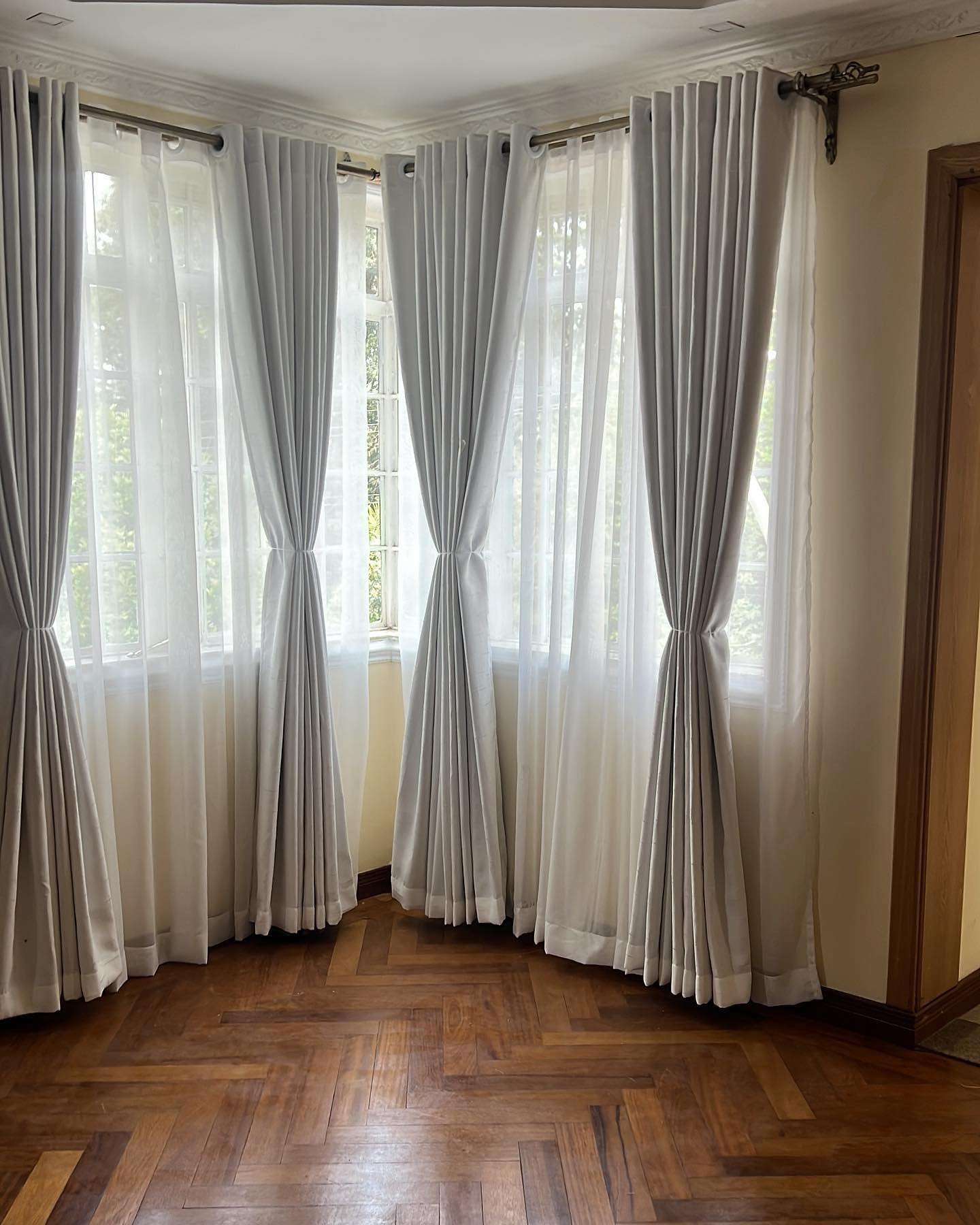 Newly installed brand new curtains neatly hanging on a window, styled by Deco Dreams Curtains installers in Nairobi.